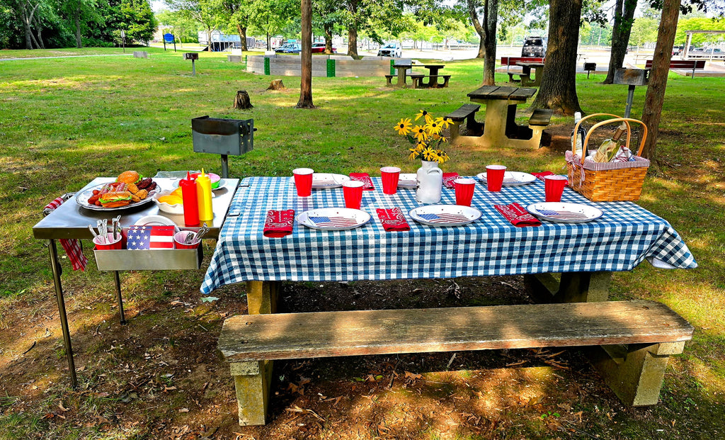 The Big John Table used as a food serving station at the end of a picnic table in a park